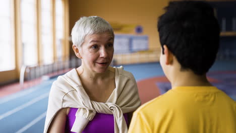 Senior-woman-talking-to-boy-indoors