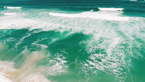 aerial drone moving fast showing endless wild sea waves breaking