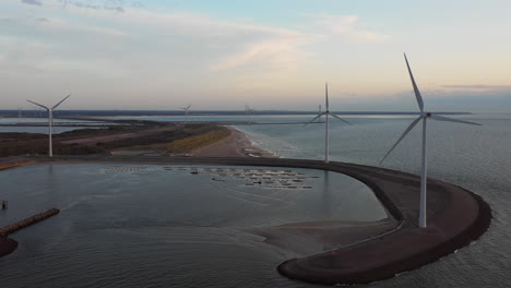 Windturbines-and-aquaculture-during-sunset-on-the-island-Neeltje-Jans,-the-Netherlands