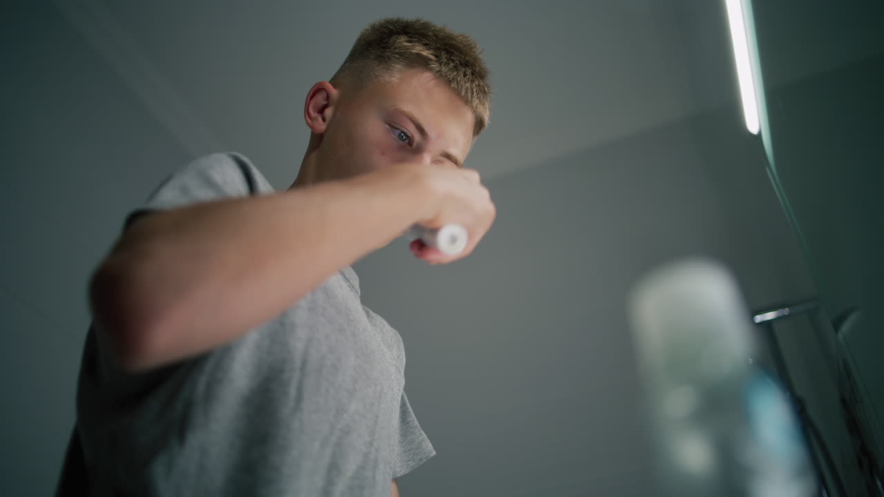 Teenage Boy Brushing His Teeth