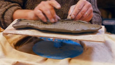 potter working on clay sculpture