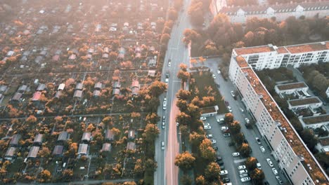 aerial view of generic city street in the morning. bird's eye view in residential area of munich. car traffic moves in sunrise of bavarian capital.