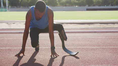 disabled mixed race man with prosthetic legs stretching