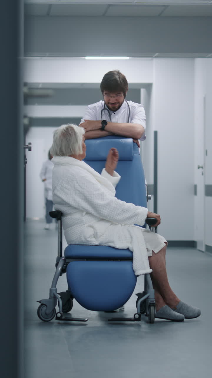 Male doctor stands with female patient in wheelcha 4k 2025 08 05 02 35 51 utc.mov | asian, bed, beside, care