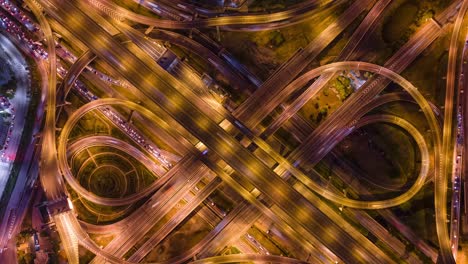 time lapse aerial view and top view of traffic on city streets in bangkok , thailand. expressway with car lots. beautiful roundabout road in the city center.