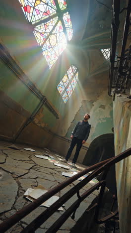 Sunlight Streaming Through Stained Glass in an Abandoned Building