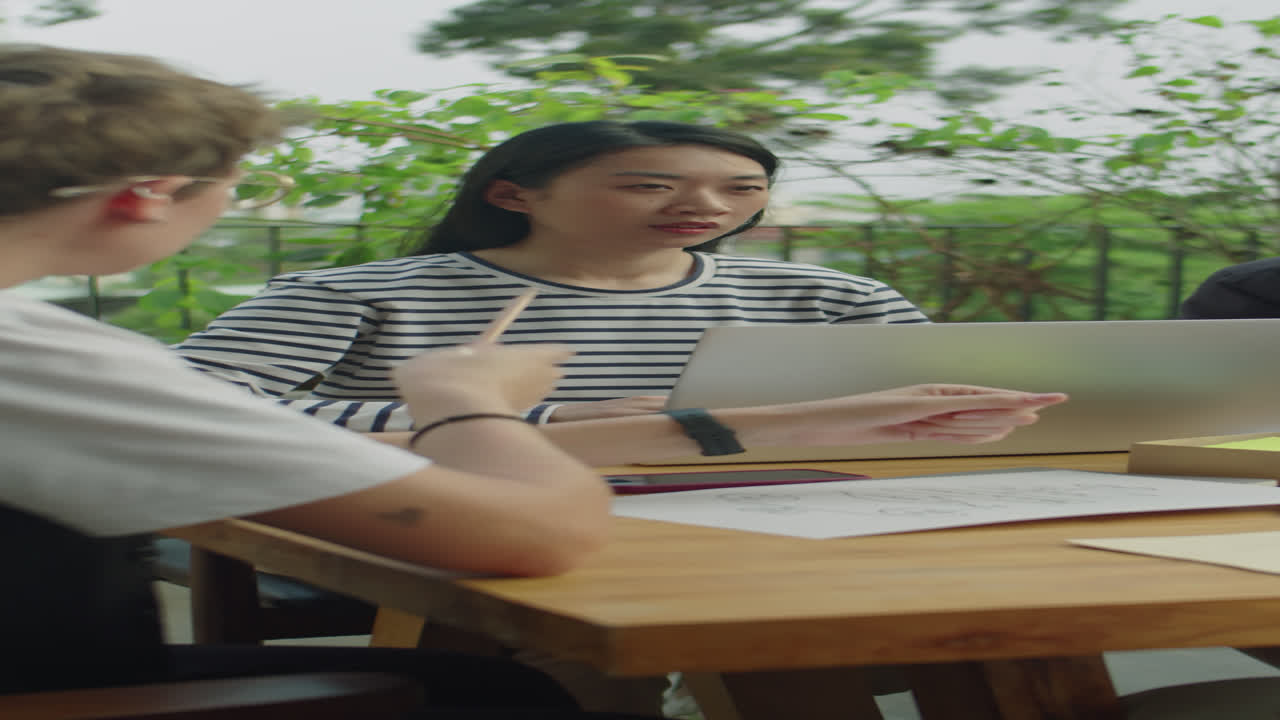 Female Colleagues Discussing Business Plans at Outdoor Meeting