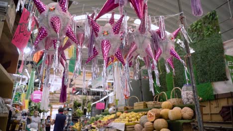colorful piñatas hanging in a mexican market