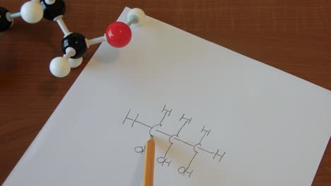 person going over a chemical formula to insure accuracy