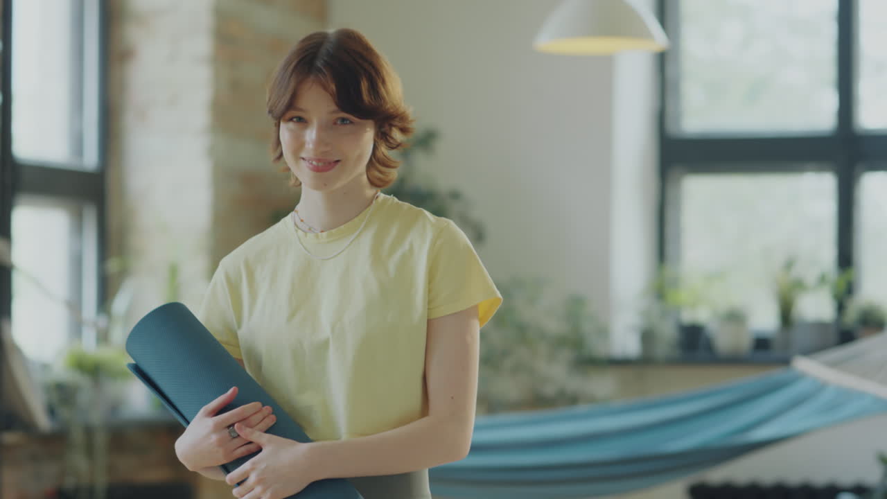 Portrait of Joyous Girl in Yoga Studio