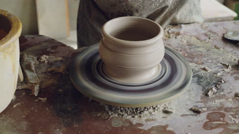 artisan creating pottery on a wheel