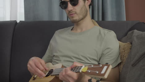 Close up view of young blind man sitting on a sofa