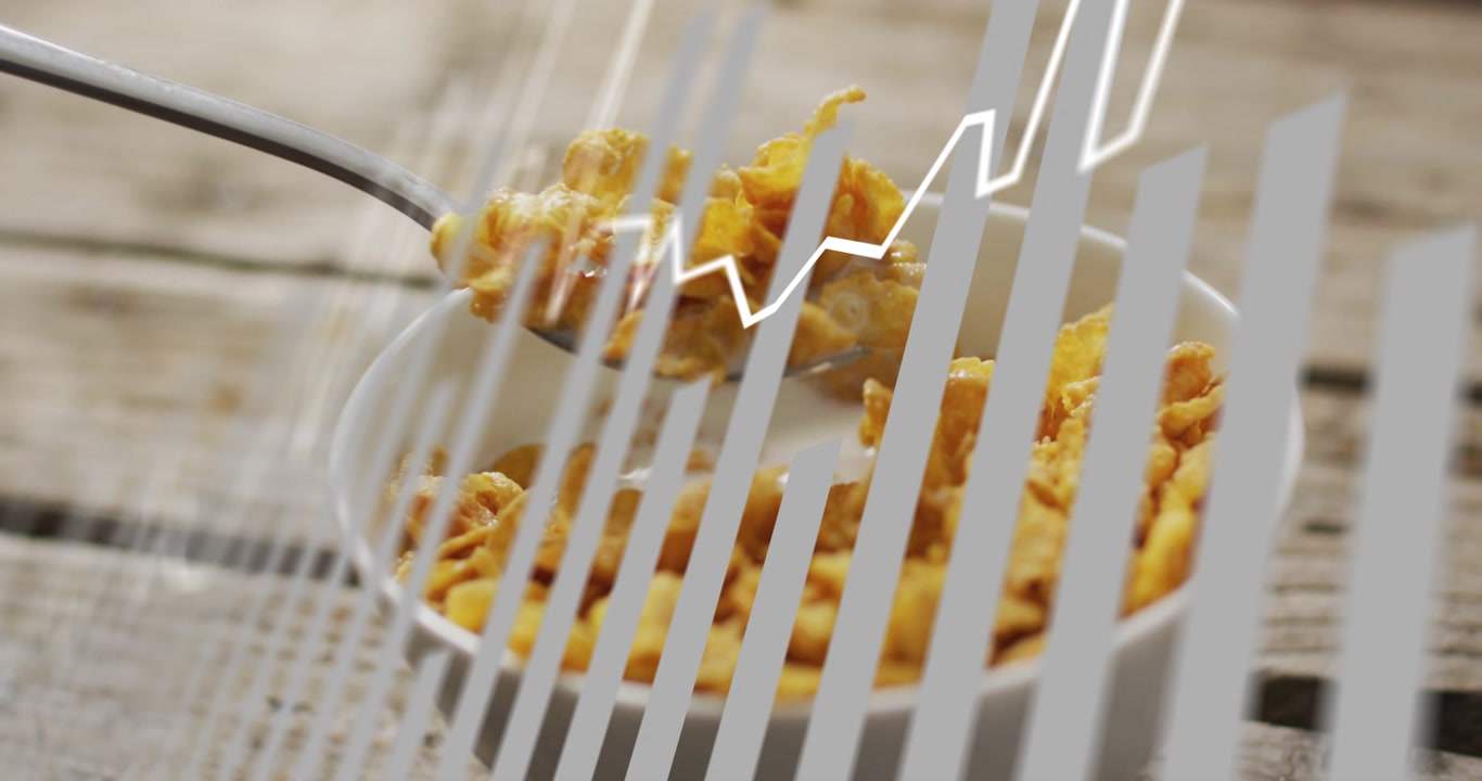 White zigzag appearing, metal spoon lifting and scooping corn flakes over bowl to showcase cereal