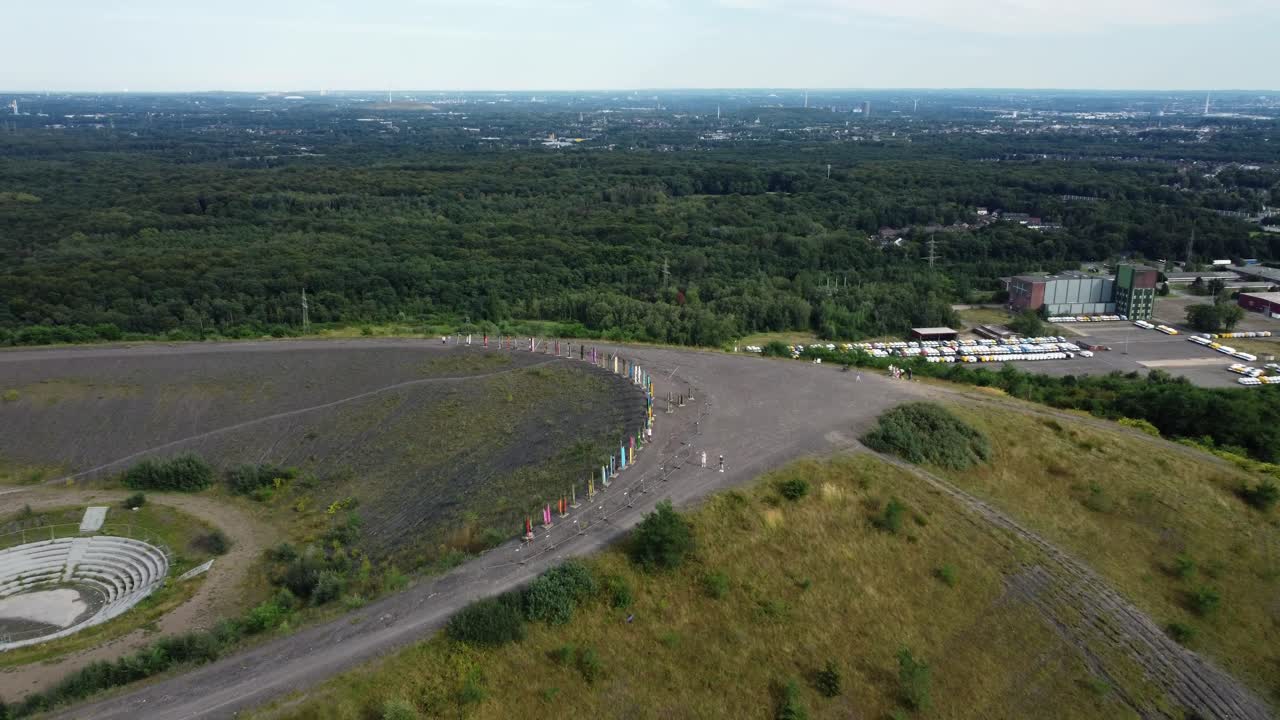 View from a hill with an open-air theater and flags
