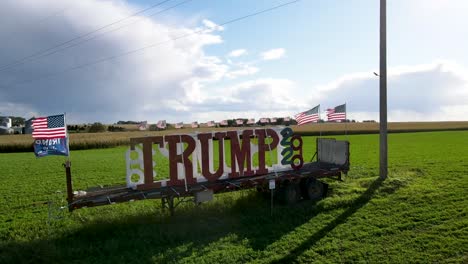 trump trailer with american flags sitting in the grassy field