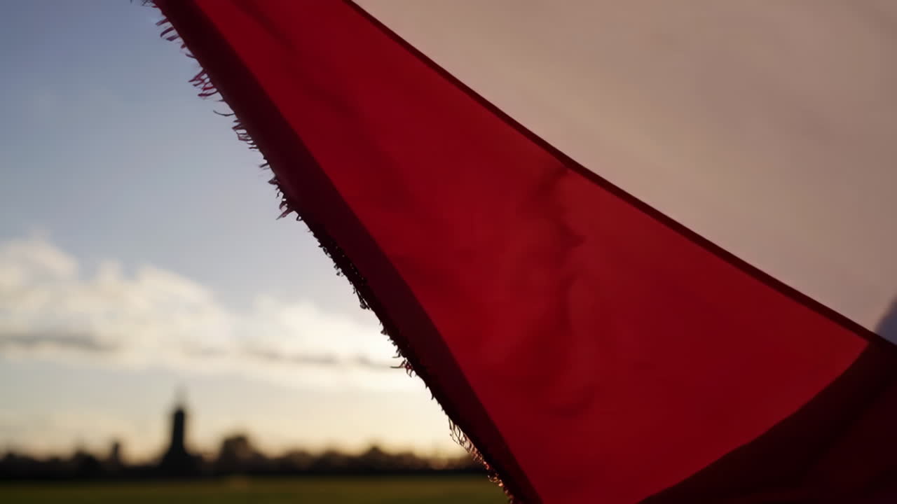 Waving Flag Against Sunset