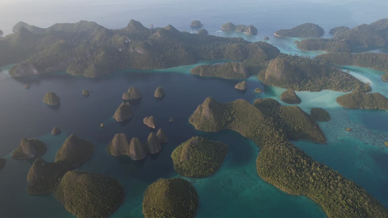 Sunset fly around many island formations, lagoons with sandy areas around in Raja Ampat, Wayag, Indonesia, Papua
