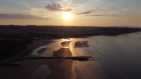 Golden-heavenly-sunset-rays-aerial-view-reflected-over-romantic-exotic-beach-coastline-high-right-dolly