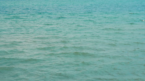 beautiful view of the sea with small gentle waves summer day with breeze and bright sun