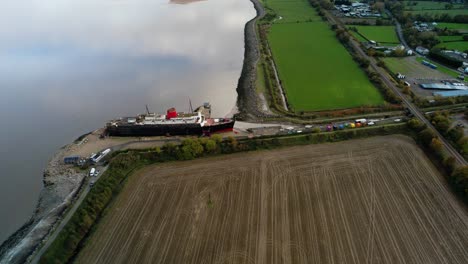 tss duke of lancaster abandoned railway steamer ship docked in mostyn docks, river dee, north wales - aerial drone shot