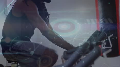 animation of data processing over biracial man exercising on stationary bike
