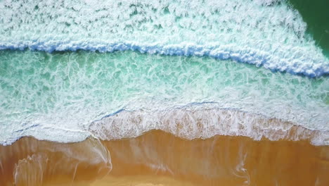 cinematic aerial drone looking down circling stunning blue water golden sand beach coastline morning surfe huge glassy waves crashing swell surf hossegor seignosse france biarritz basque country