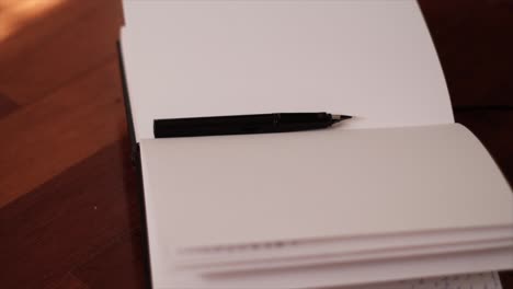 reflections of creativity: notebook and fountain pen in slow motion dance