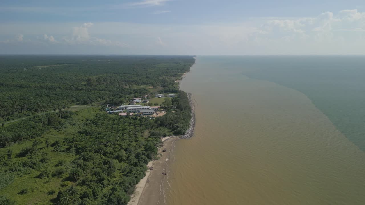 Aerial Drone View During Summer Alit Fishing Village,Kabong With, Facing Open Blue Sea, White Sandy Beach,Green Coconut, Palm Trees,And River,Sarawak,Borneo