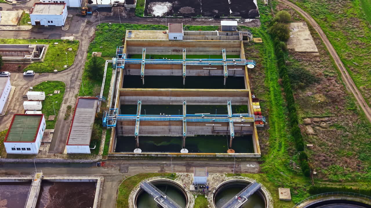 Water treatment facility showcasing advanced technology and green landscape during bright daylight hours