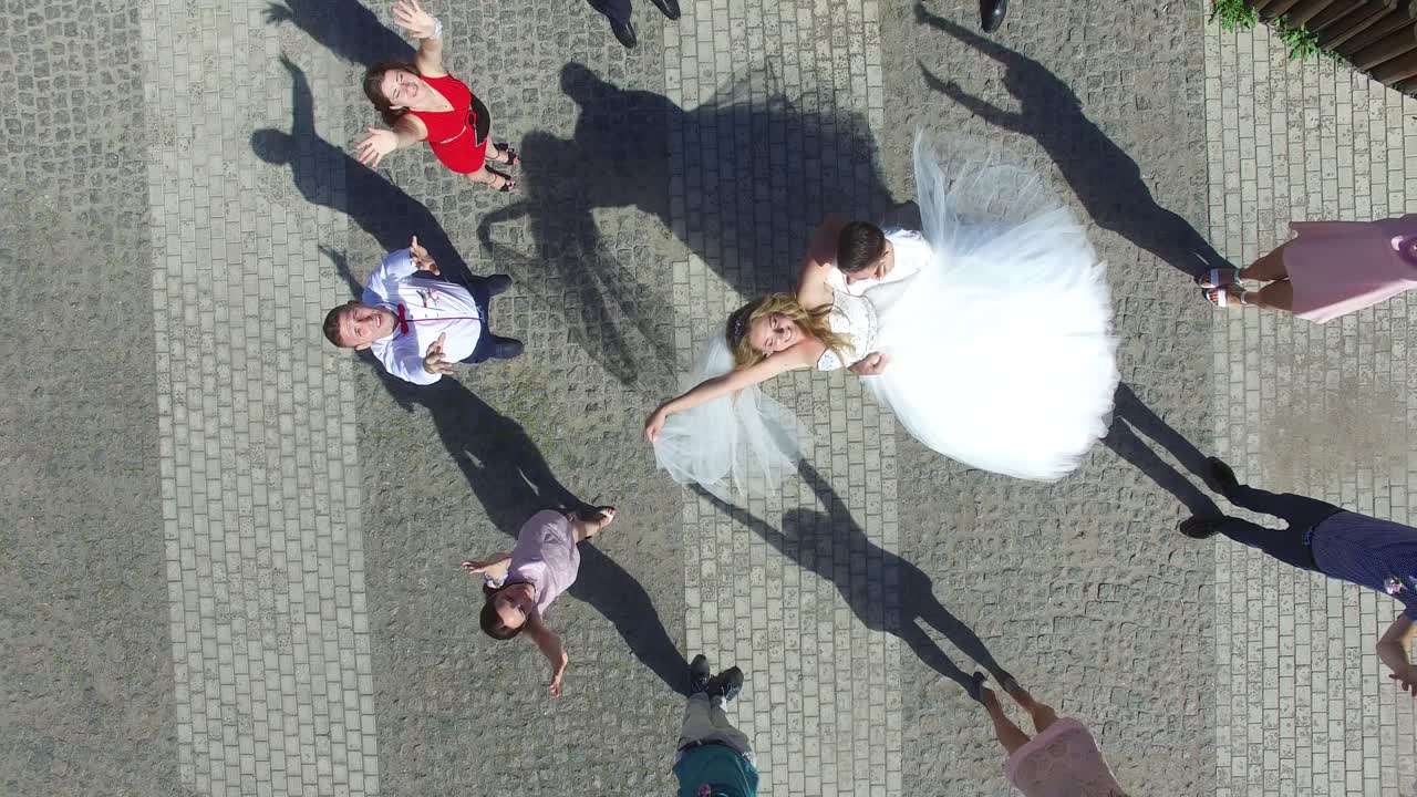 Newlywed Couple And Their Friends. VINNITSA, UKRAINE - AUGUST 2016: Aerial shot of a newlywed couple and their friends at the wedding party