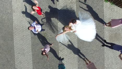newlywed couple and their friends. vinnitsa, ukraine - august 2016: aerial shot of a newlywed couple and their friends at the wedding party