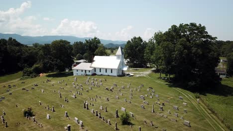 aerial push into church chapel with mountain backdrop near abington virginia