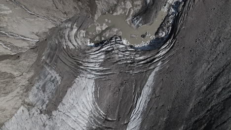 Drone-shot-revealing-Pasterze-glacier-melting-landscape-covered-in-moraine-due-to-global-warming-and-climate-change
