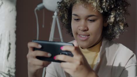 young woman playing a mobile game