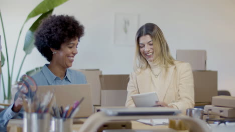 two happy young businesswomen working in office and cheering