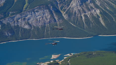 a thrilling helicopter tour of the canadian rocky mountains, breathtaking aerial views of snow-capped peaks, glaciers, rivers, and forests