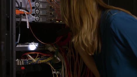 technician looking at open server locker