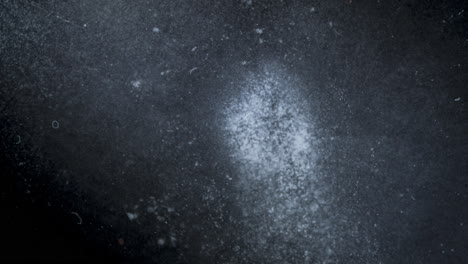 Dissolving pill in liquid, abstract close-up timelapse showing particles dispersing