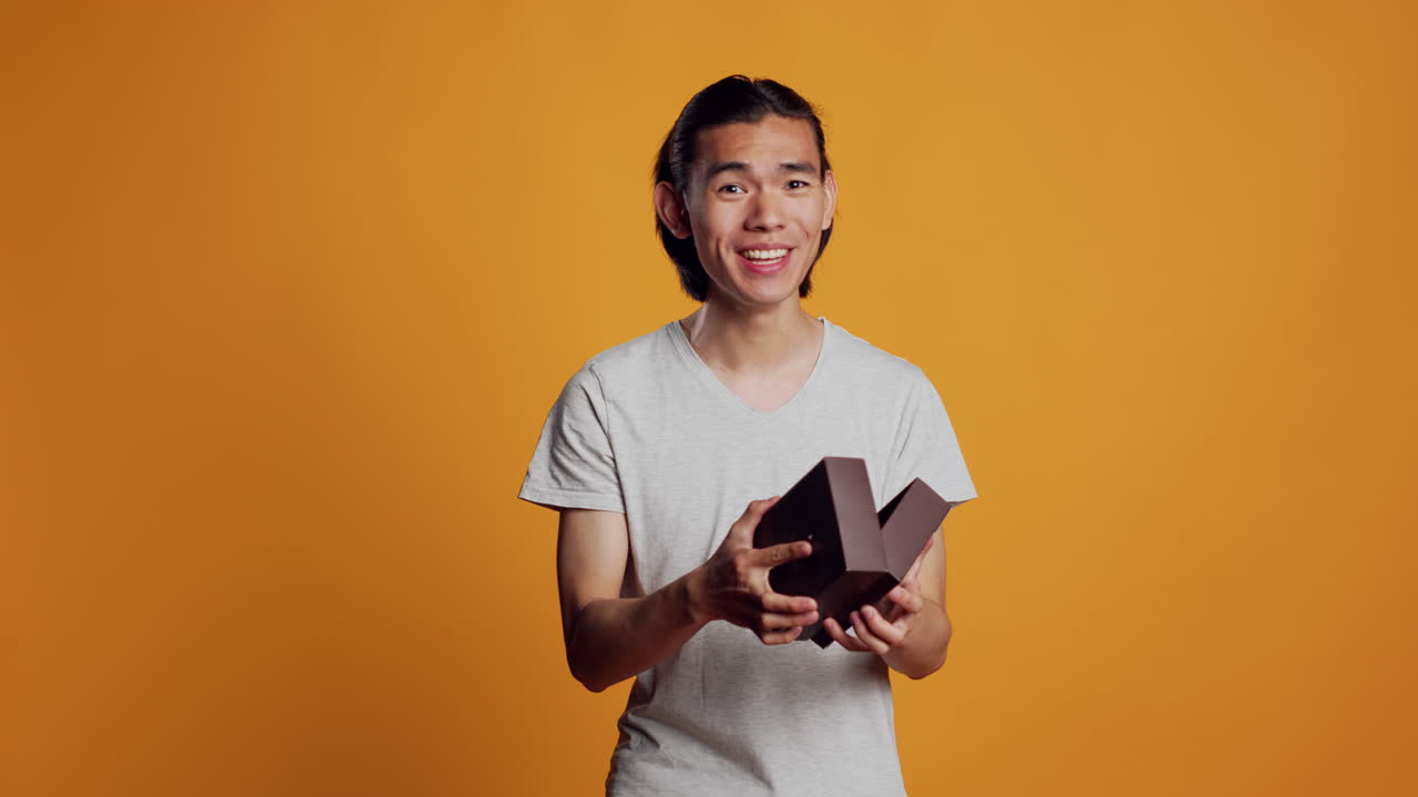 Excited male model receiving present in box