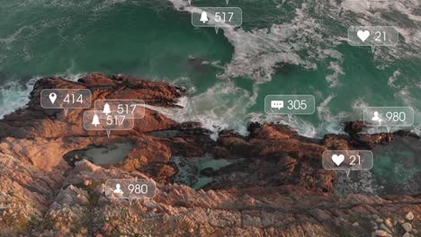 Animation-of-social-media-icons-over-rocky-shore-and-sea-landscape