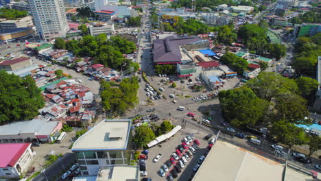 aerial drone cinematic establishing shot of busy asian city intersection with cars and motorbikes driving through