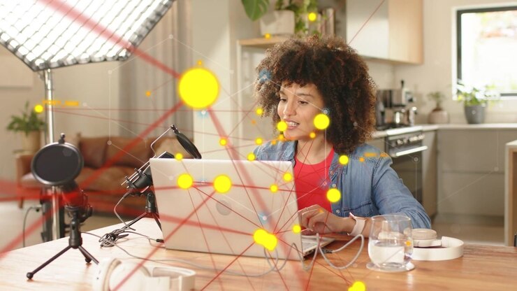 Woman host typing laptop nodes and lines forming across shot leaning speaking adjusting mic podcast