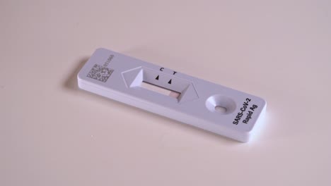 rapid covid antigen test in use - closeup of test with red line slowly moving upward before giving answer - static