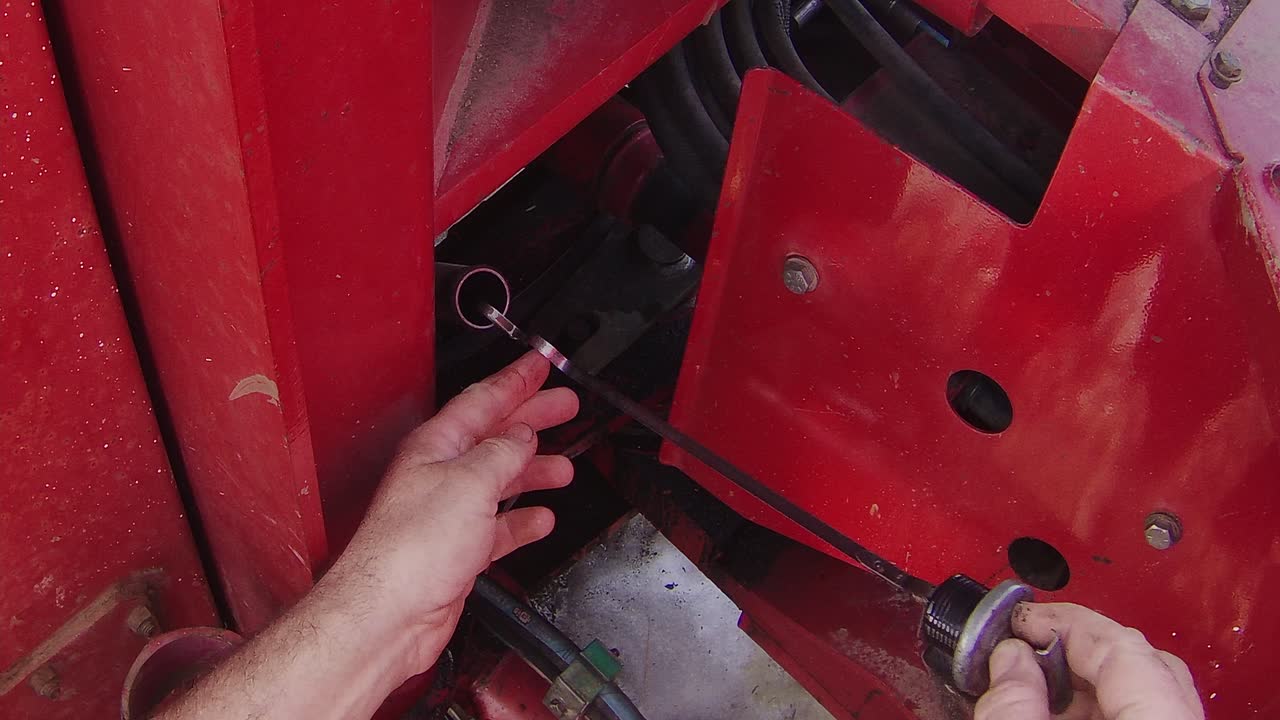 Checking transmission oil level in a large articulated tractor