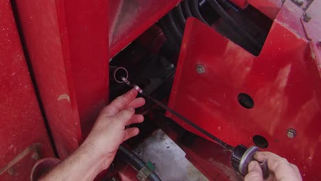 checking transmission oil level in a large articulated tractor