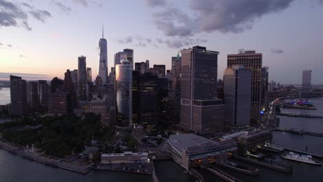 Leaving-the-Manhattan-cityscape,-vibrant-evening-sky-in-NYC,-USA---Aerial,-pull-back,-End-screen