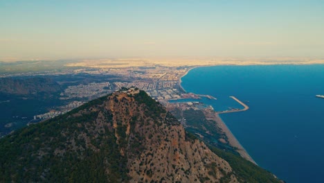 Aerial-4K-drone-video-of-a-Tunektepe-Teleferik
Cable-station-positioned-on-top-of-the-hill-with-the-mountains-in-the-background