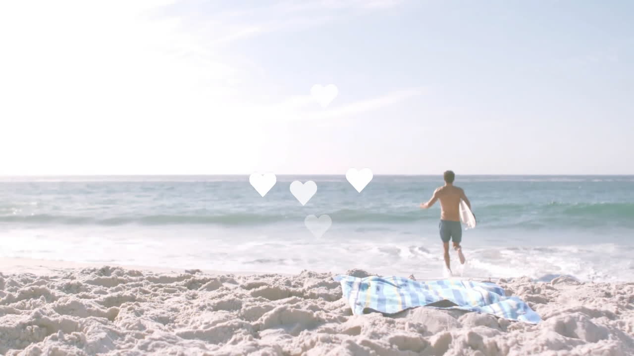 Person running towards ocean with hearts animation over sandy beach scene