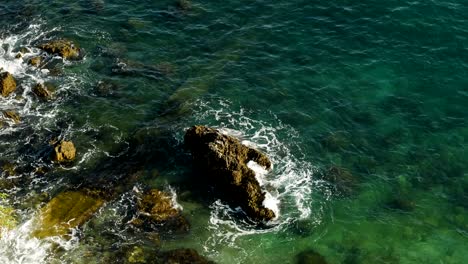 waves beating on the rocks on the beach in montenegro