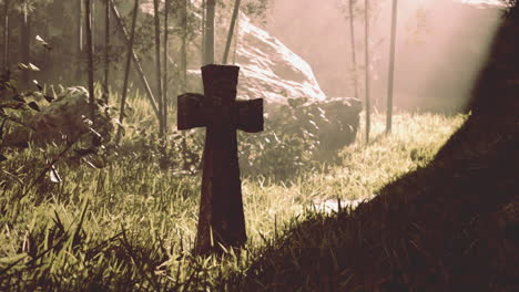 stone cross in a foggy forest